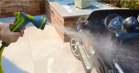 cleaning ride on car using soap and water